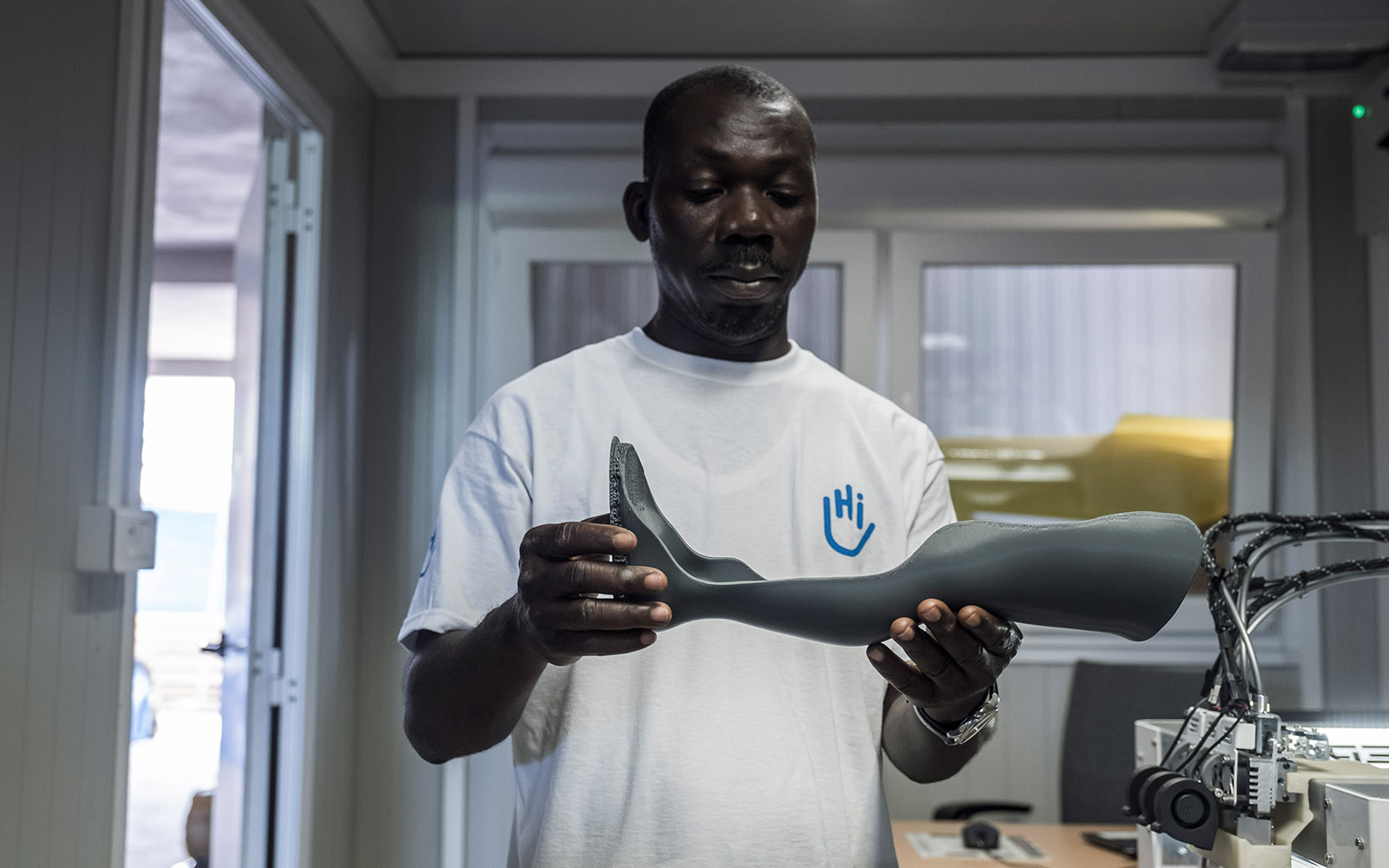 Togo, Lomé, technician, Fabrice DJODJI, checks a 3D printed orthosis. HI, as part of the IMP&ACTE 3D project, is using 3D technology for a clinical trial.