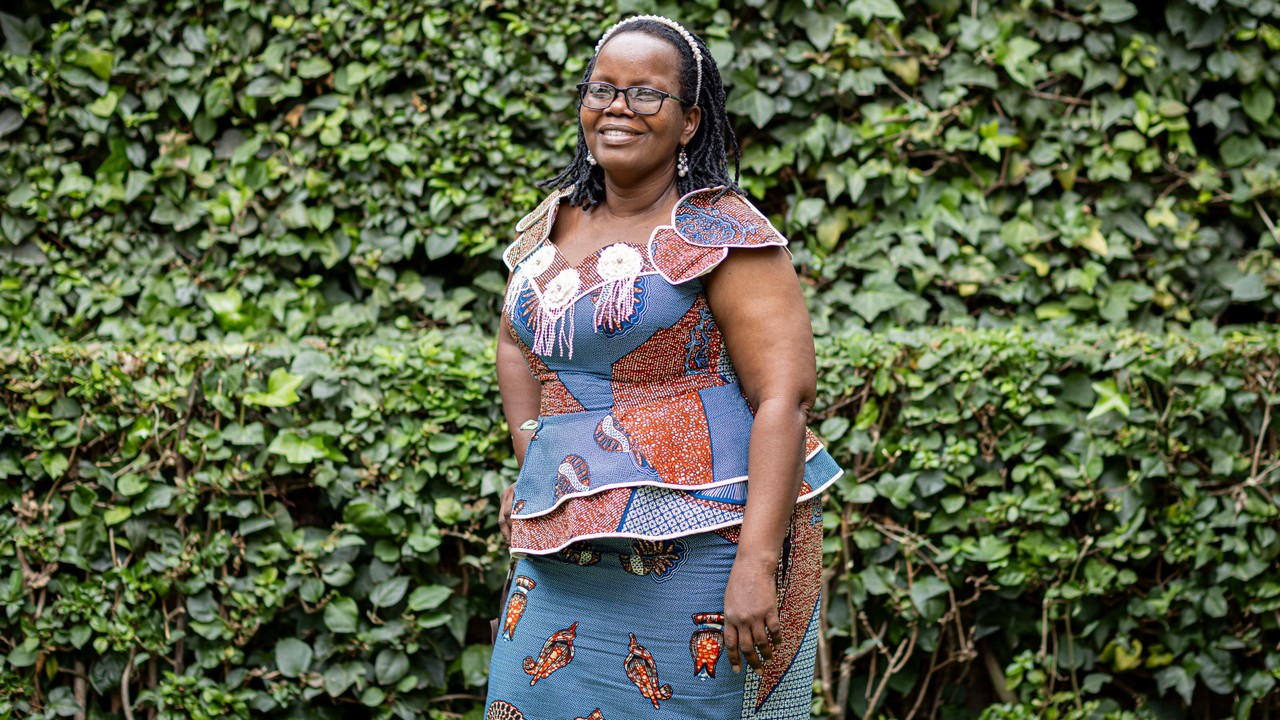 Smiling woman posing for a photo in a garden.