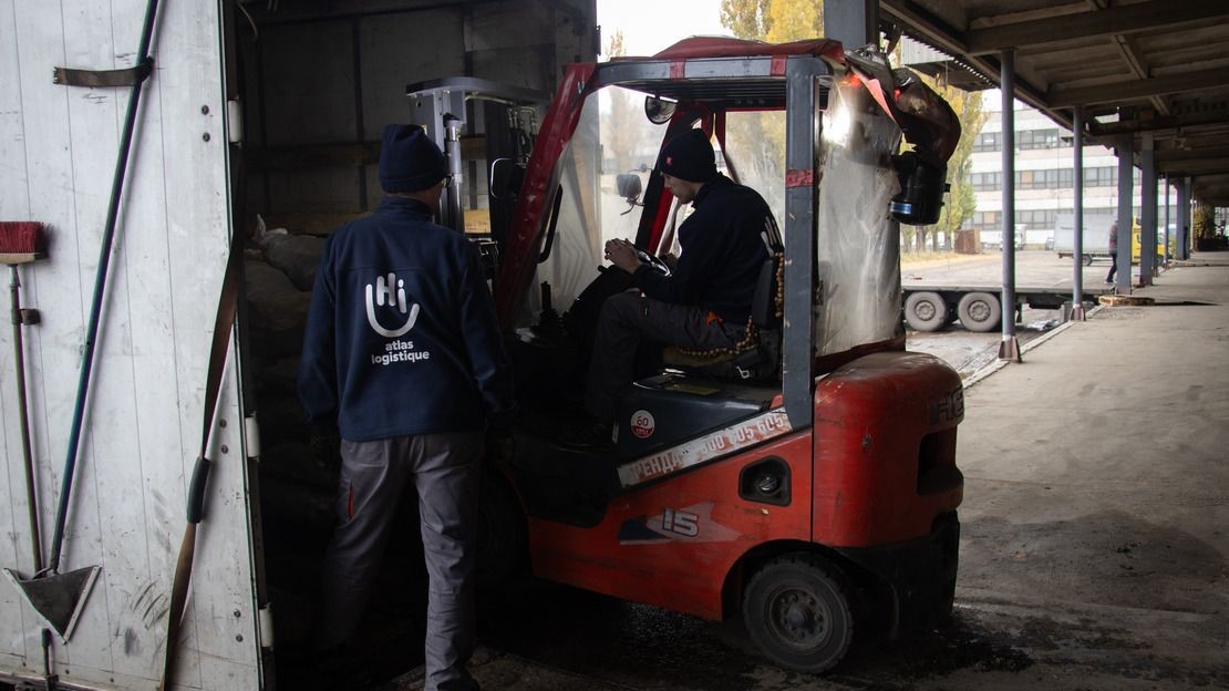 Atlas Logistique agents load solid fuel briquettes into a truck in November 2024 in Dnipro, eastern Ukraine. ; }}