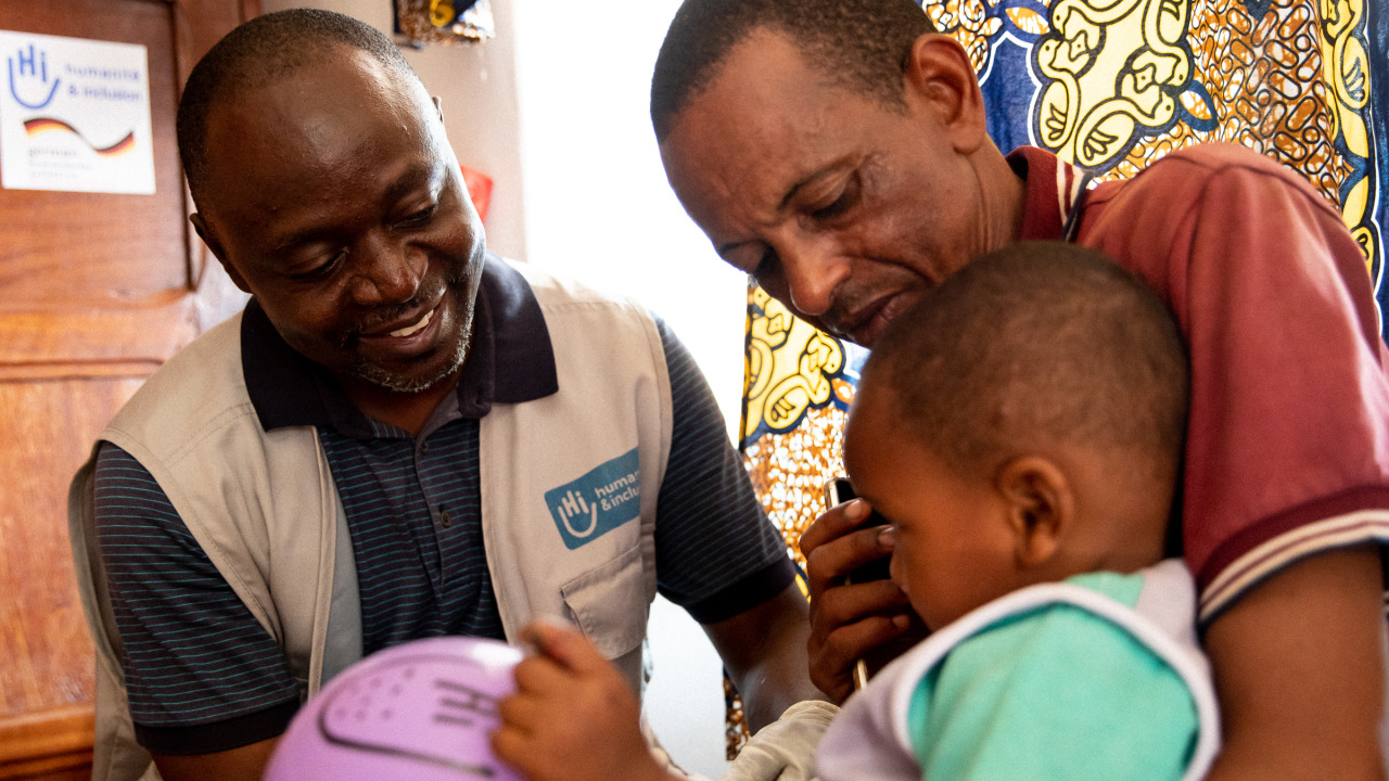 An HI physiotherapist works with a young patient in Bambari