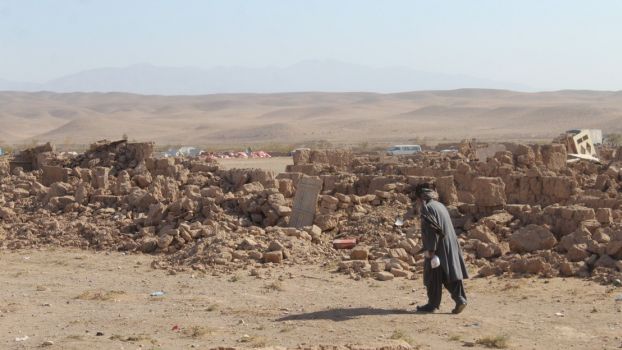 Archive photo: Damage caused by three consecutive earthquakes that struck the province of Herat in Afghanistan in October 2023. A man walks in front of a field of bricks and stones, the remains of collapsed buildings.; }}